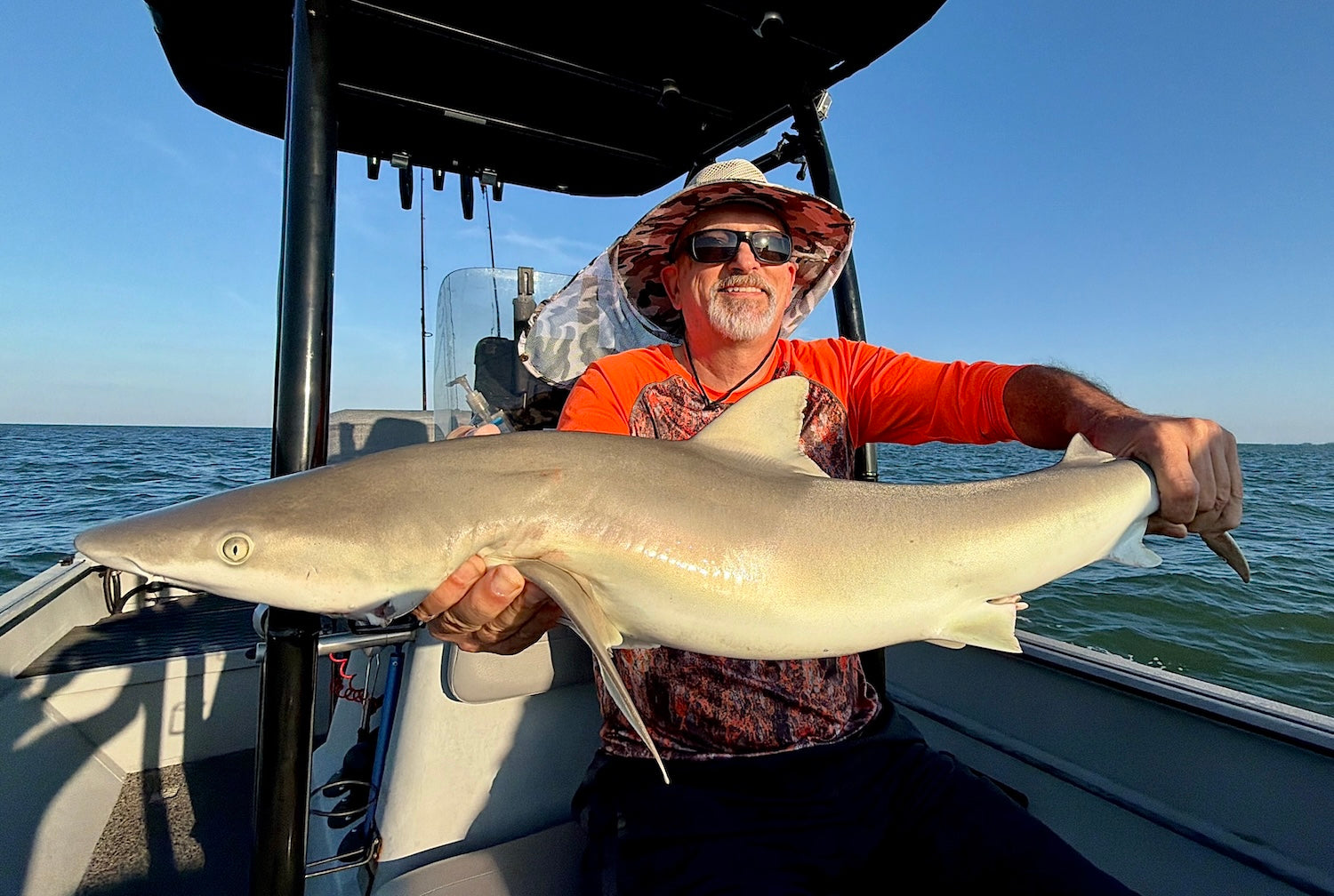 Man holding a Blacknose shark on a charter boat in Crystal River, Florida